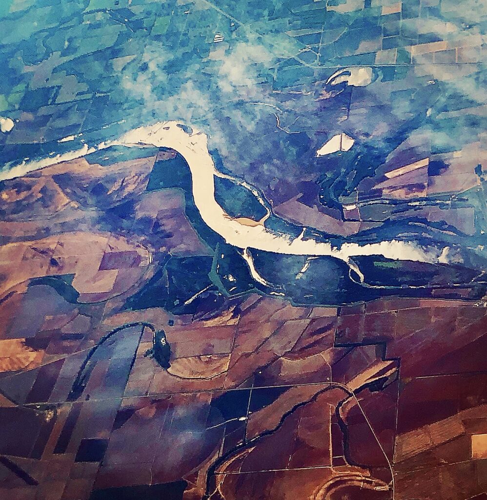 Abstract aerial landscape with flowing river patterns and earthy tones, contemporary digital art by Layne Morgan