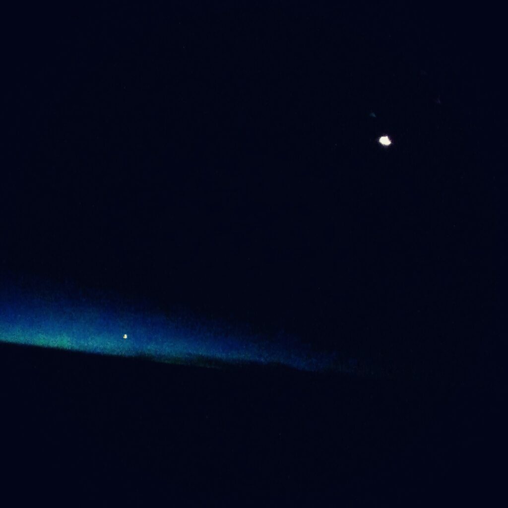 Dark blue abstract horizon with subtle light glow and single bright point, minimalist digital art by Layne Morgan