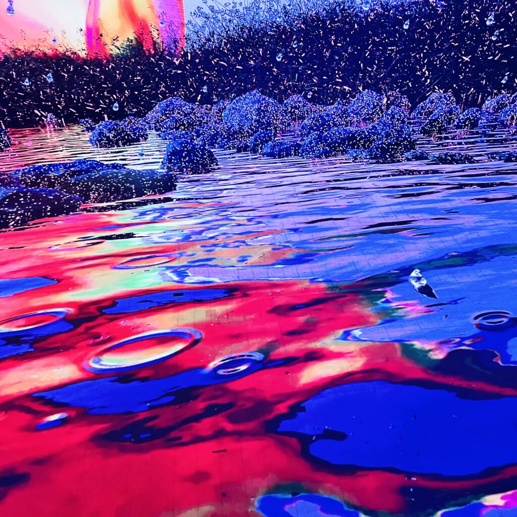 Layne Morgan abstract light painting photography with vibrant blue and red reflections on water