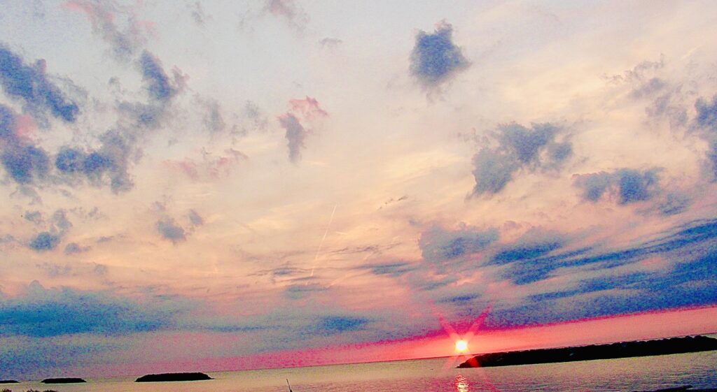 Pastel sunset clouds with soft pink and blue sky photographed by Layne Morgan