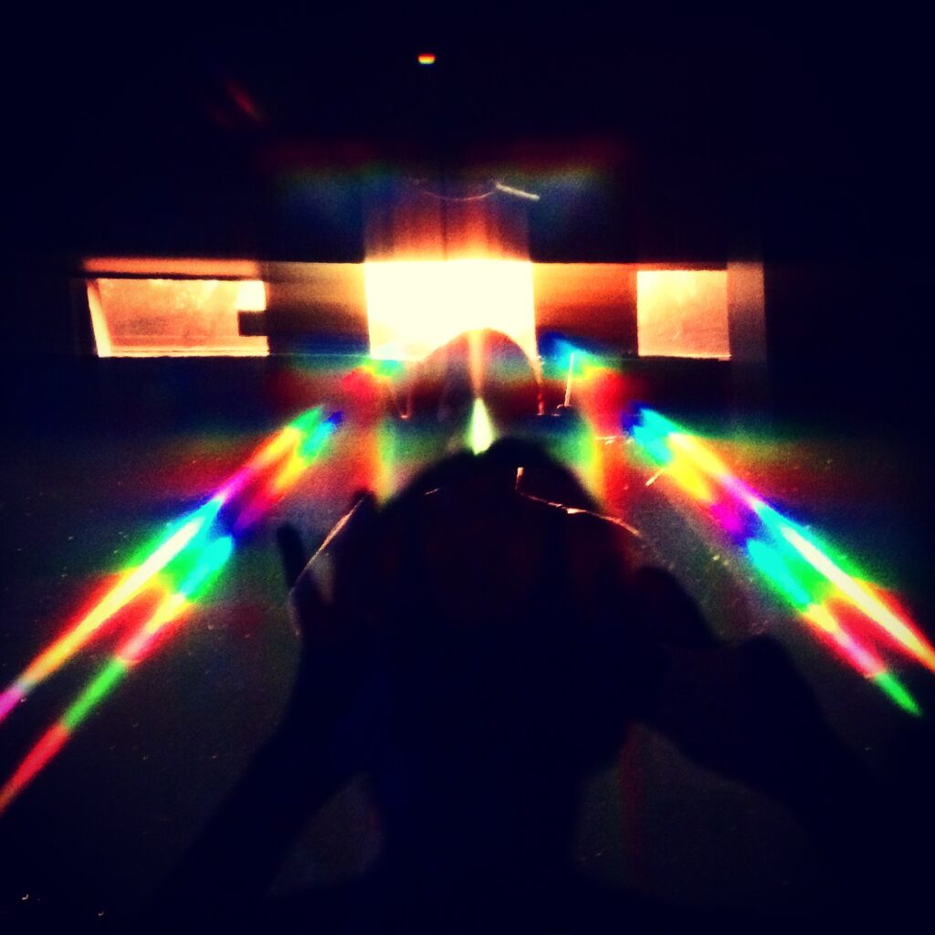Abstract rainbow prism light beams in darkness – experimental light photography by Layne Morgan