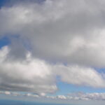 White cumulus clouds in blue sky – fine art cloudscape photography by Layne Morgan