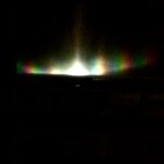 Abstract rainbow light refraction on dark background – fine art photography by Layne Morgan