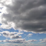 Dark storm clouds above blue horizon – fine art cloudscape photography by Layne Morgan