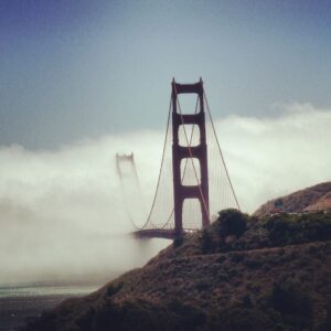 Golden Gate Bridge tower rising above coastal fog San Francisco fine art architectural photography by Layne Morgan