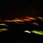 Abstract green and yellow light trails captured with long exposure – experimental photography by Layne Morgan