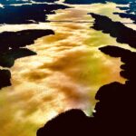 Golden light reflecting on water forming abstract shoreline patterns – fine art photography by Layne Morgan