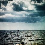 Dramatic clouds above ocean horizon – fine art sky and seascape photography by Layne Morgan