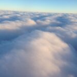 Soft cloud wave formation in blue sky – fine art cloudscape photography by Layne Morgan