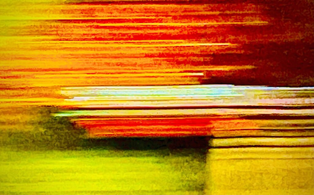 Abstract color field photograph with streaks of red, orange, and yellow light over a glowing horizon by Layne Morgan