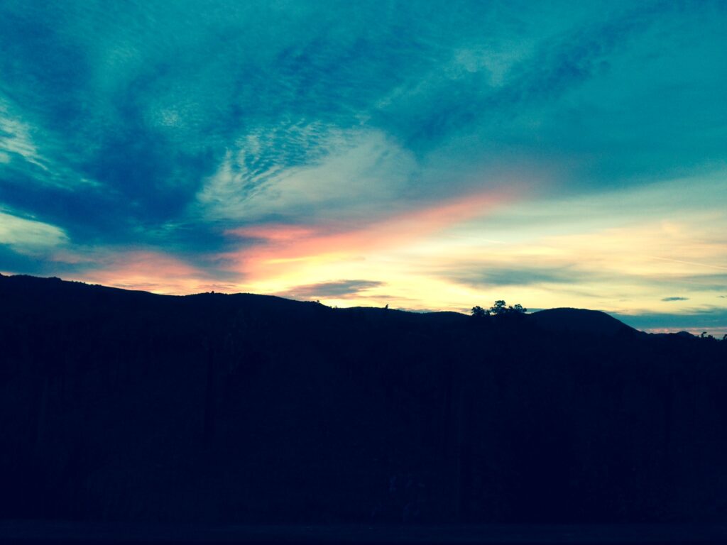 Turquoise twilight sky above mountain silhouette – fine art sky photograph by Layne Morgan