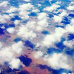 Colorful aerial cloudscape with sunlight reflections – fine art sky photography by Layne Morgan