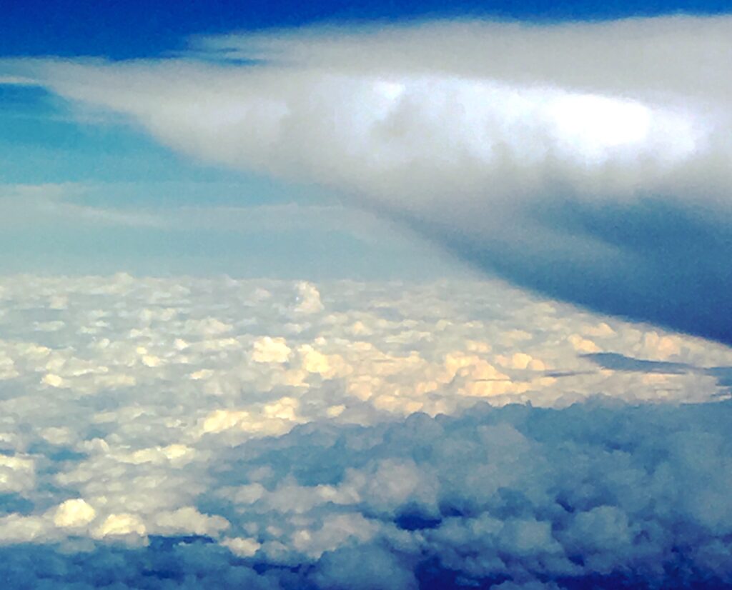 Aerial cloud formation above landscape – fine art sky photography by Layne Morgan