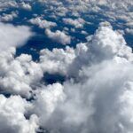 Towering cumulus clouds against deep blue sky – fine art cloudscape photography by Layne Morgan