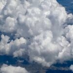 Dramatic textured cumulus clouds against deep blue sky – fine art cloudscape photography by Layne Morgan