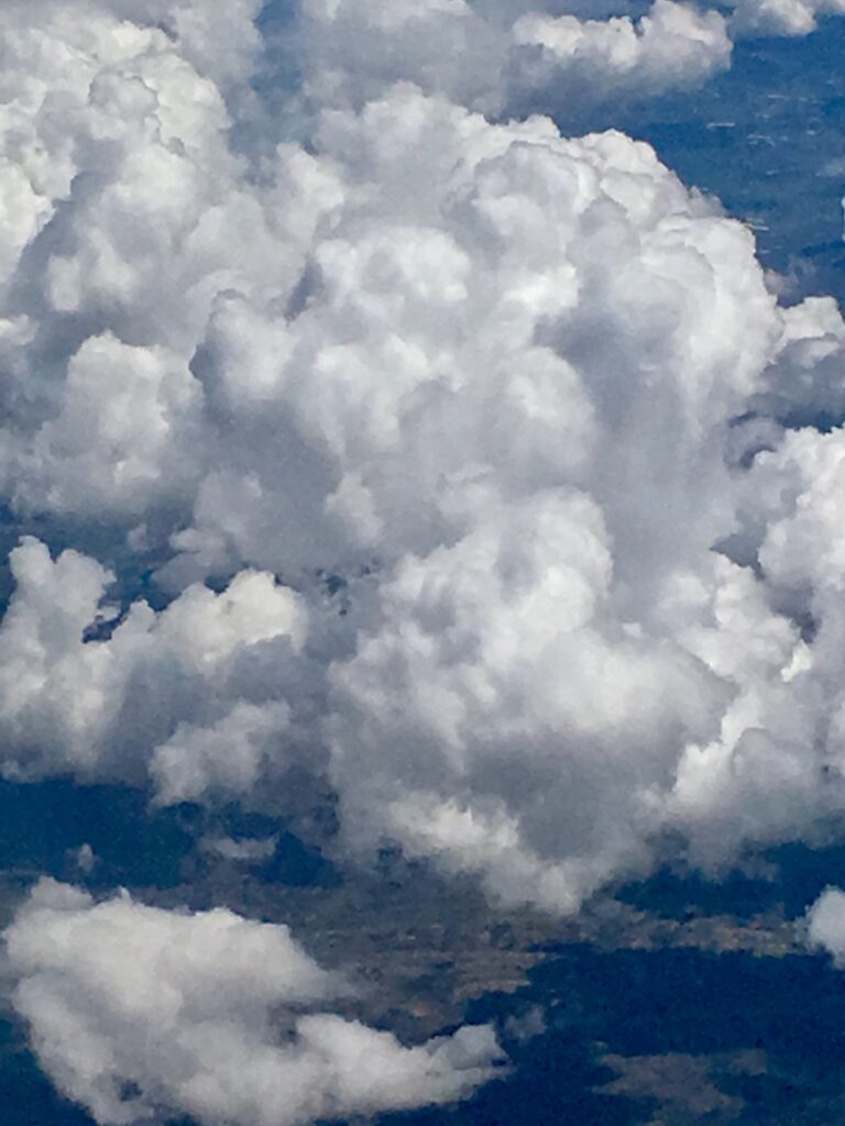 Dramatic textured cumulus clouds against deep blue sky – fine art cloudscape photography by Layne Morgan