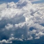 Soft white cumulus clouds in bright blue sky – fine art cloudscape photography by Layne Morgan