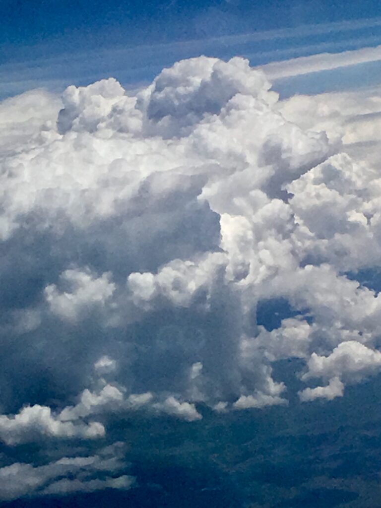 Soft white cumulus clouds in bright blue sky – fine art cloudscape photography by Layne Morgan