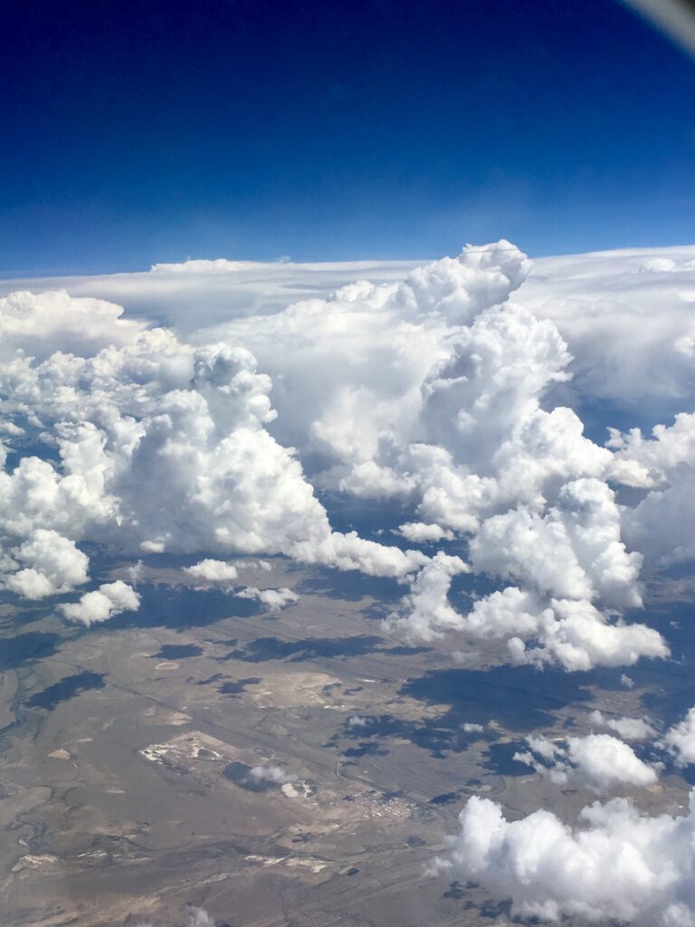Towering clouds above the landscape seen from an aerial perspective