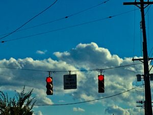 Traffic lights suspended against blue sky urban street infrastructure fine art photography by Layne Morgan