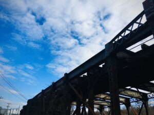 Elevated rail structure and urban overpass architecture against blue sky fine art photography by Layne Morgan