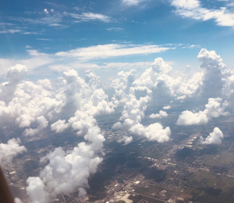 Towering cloud formations above the earth captured from an aerial view