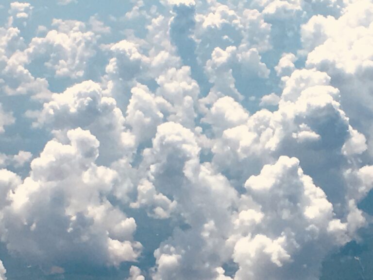 Towering cumulus cloud formation seen from above in an aerial cloudscape