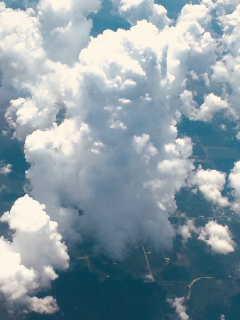 Towering cumulus clouds rising high above the earth in an aerial cloudscape