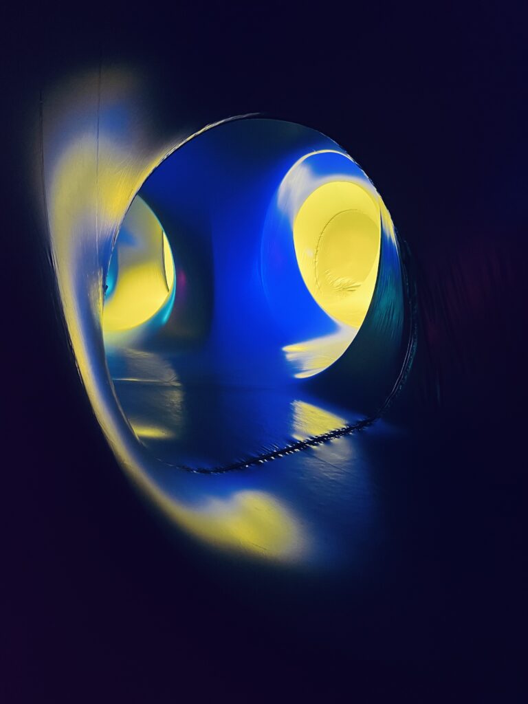 Abstract glowing blue sphere with yellow light shapes and soft reflections