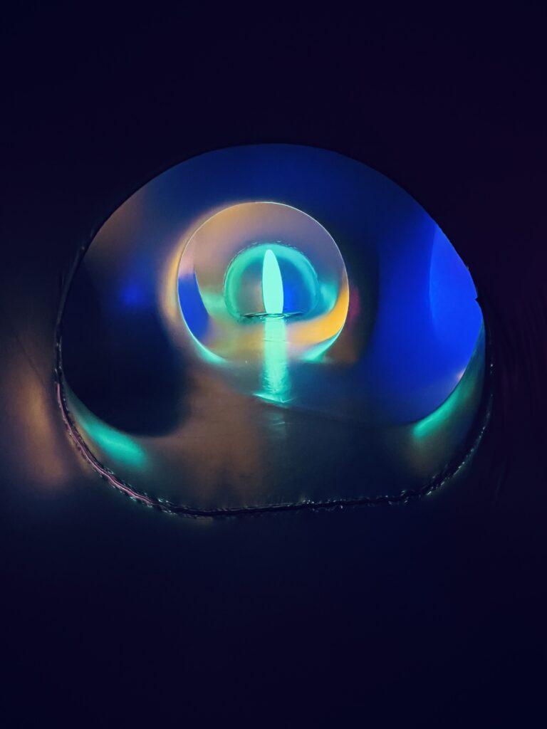 Glowing abstract blue light forming a circular portal with soft neon gradients