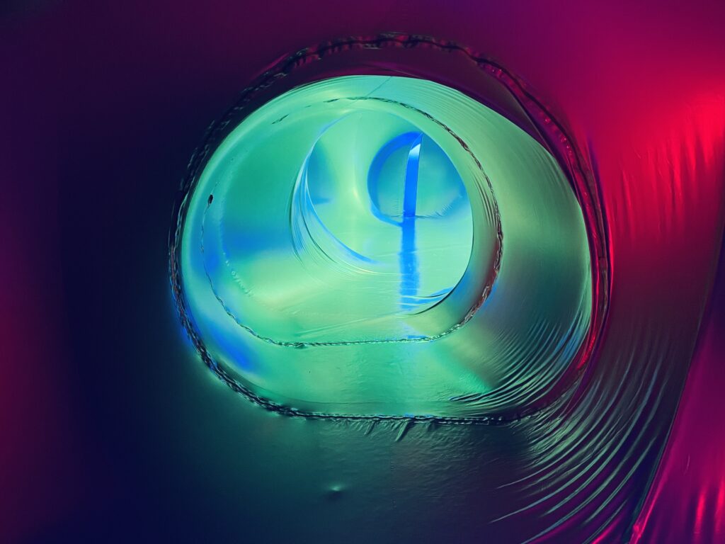 Abstract teal and green glowing light with fluid circular motion and soft gradients