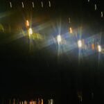 Abstract photograph of soft glowing lights in a dark, foggy setting, creating an atmospheric and cinematic fine art composition